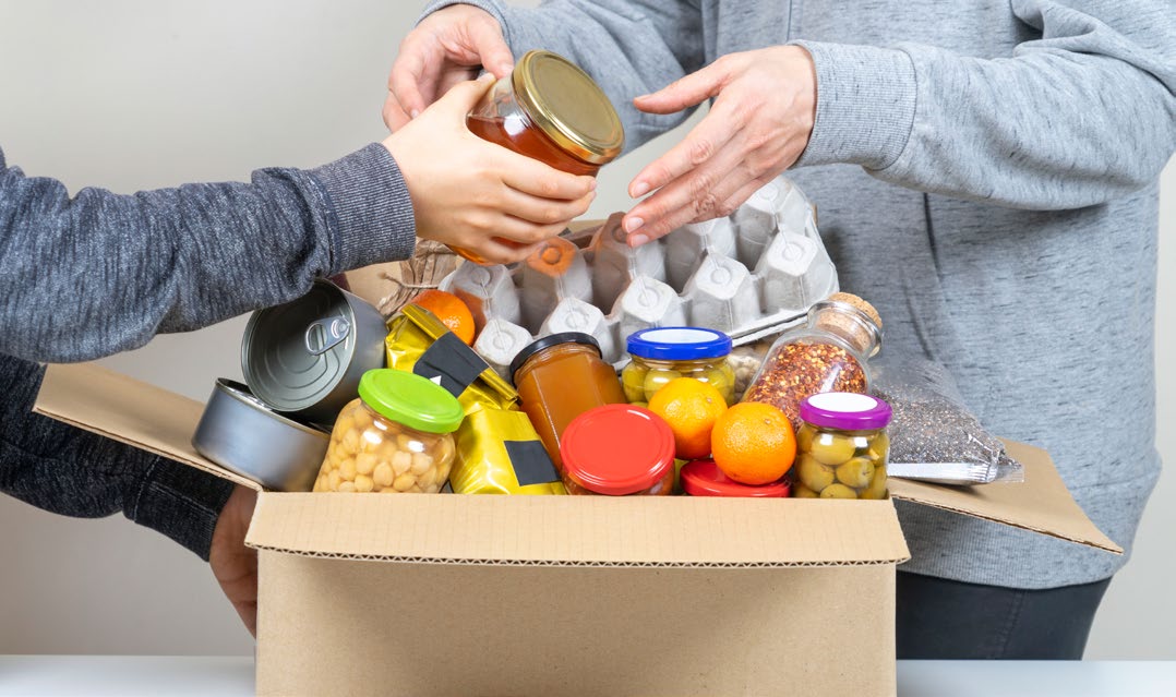 A person giving another person a box of food